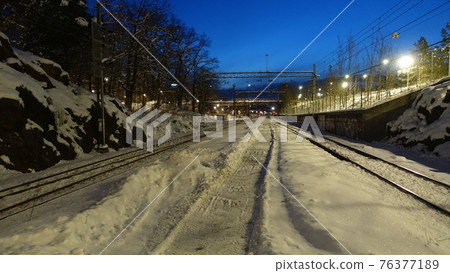 A perspective of the rails of a train station at dawn in northern Europe A perspective of the rails of a train station at dawn in northern Europe 76377189