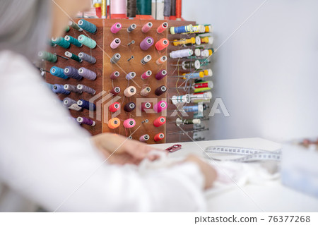 Special stand with colored threads and sewing hands Special stand with colored threads and sewing hands 76377268