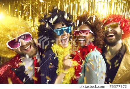 Happy crazy friends in funny wigs, eyeglasses celebrate party headshot portrait Happy crazy friends in funny wigs, eyeglasses celebrate party headshot portrait 76377372