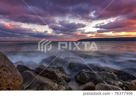 rocky shore with motion blur water rocky shore with motion blur water 76377406