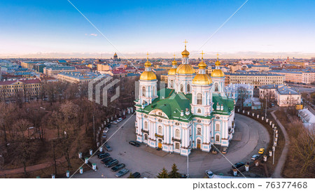 Aerial top view to St. Nicholas Naval Sea Cathedral in sunny day. Panorama of evening historical city center. Orthodox church located on banks of Kryukov and Griboyedov canal. Saint Petersburg. Russia Aerial top view to St. Nicholas Naval Sea Cathedral in sunny day. Panorama of evening historical city center. Orthodox church located on banks of Kryukov and Griboyedov canal. Saint Petersburg. Russia 76377468
