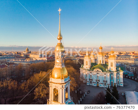 Aerial top view to St. Nicholas Naval Sea Cathedral in sunny day. Panorama of evening historical city center. Orthodox church located on banks of Kryukov and Griboyedov canal. Saint Petersburg. Russia Aerial top view to St. Nicholas Naval Sea Cathedral in sunny day. Panorama of evening historical city center. Orthodox church located on banks of Kryukov and Griboyedov canal. Saint Petersburg. Russia 76377470
