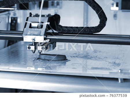 3D printer prints the form of molten plastic blue close-up 3D printer prints the form of molten plastic blue close-up 76377539