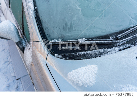 Car covered with ice and icicles after freezing rain. Ice covered car window close up. Bad winter weather, ice stormWinter frosty scenes. Car covered with ice and icicles after freezing rain. Ice covered car window close up. Bad winter weather, ice stormWinter frosty scenes. 76377995