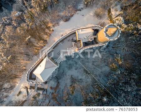 Aerial view of medieval castle Kokorin in winter during sunrise. National park Kokorinsko nearby Prague in Czech Republic. Central Europe. 76378053