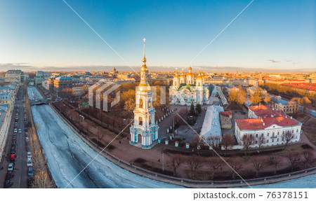 Aerial top view to St. Nicholas Naval Sea Cathedral in sunny day. Panorama of evening historical city center. Orthodox church located on banks of Kryukov and Griboyedov canal. Saint Petersburg. Russia Aerial top view to St. Nicholas Naval Sea Cathedral in sunny day. Panorama of evening historical city center. Orthodox church located on banks of Kryukov and Griboyedov canal. Saint Petersburg. Russia 76378151