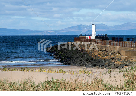 Isle of Arran Scotland from Ayr Beach with Harbour Light Isle of Arran Scotland from Ayr Beach with Harbour Light 76378164