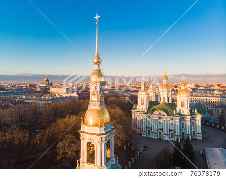 Aerial top view to St. Nicholas Naval Sea Cathedral in sunny day. Panorama of evening historical city center. Orthodox church located on banks of Kryukov and Griboyedov canal. Saint Petersburg. Russia Aerial top view to St. Nicholas Naval Sea Cathedral in sunny day. Panorama of evening historical city center. Orthodox church located on banks of Kryukov and Griboyedov canal. Saint Petersburg. Russia 76378179