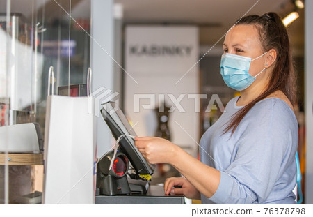 Saleswoman or shopgirl hands over the recepit or invoice by the shopping in the shop center, cloth sale concept Saleswoman or shopgirl hands over the recepit or invoice by the shopping in the shop center, cloth sale concept 76378798