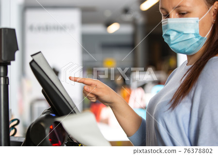 Saleswoman or shopgirl hands over the recepit or invoice by the shopping in the shop center, cloth sale concept Saleswoman or shopgirl hands over the recepit or invoice by the shopping in the shop center, cloth sale concept 76378802