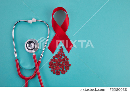 Awareness oncept with blood drop and red ribbon. World Hamophilia day or blood donor day Awareness oncept with blood drop and red ribbon. World Hamophilia day or blood donor day 76380088