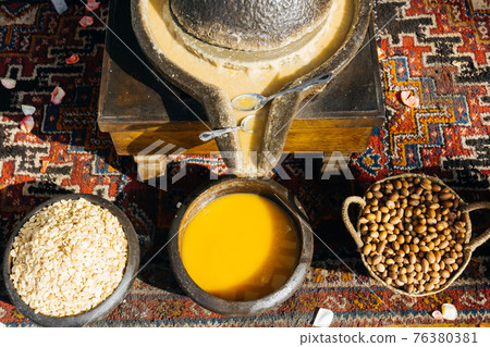 ARGAN OIL. Making of argan oil from argan nuts and seeds in Morocco ARGAN OIL. Making of argan oil from argan nuts and seeds in Morocco 76380381