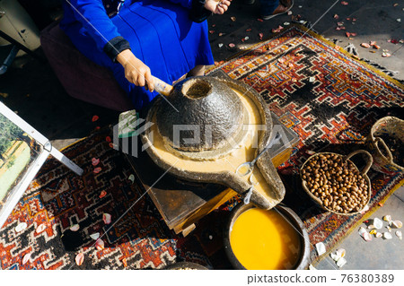 ARGAN OIL. Making of argan oil from argan nuts and seeds in Morocco 76380389