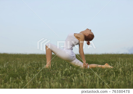 Fit female doing Crescent Lunge on the Knee Fit female doing Crescent Lunge on the Knee 76380478