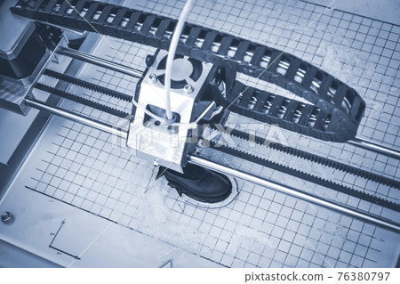 3D printer prints the form of molten plastic blue close-up. 76380797