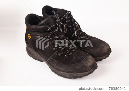 Hiking shoes and a white background, Sturdy hiking boots Hiking shoes and a white background, Sturdy hiking boots 76380941