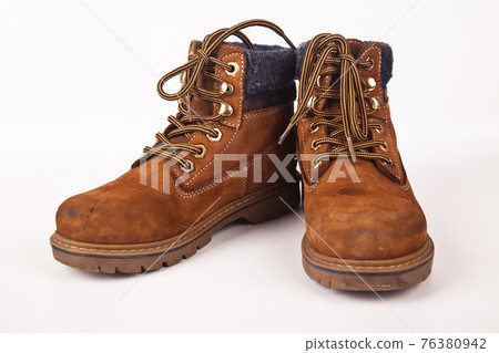 Hiking shoes and a white background, Sturdy hiking boots Hiking shoes and a white background, Sturdy hiking boots 76380942