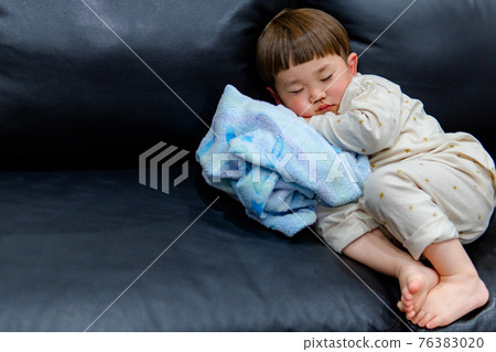 Sleeping face of a child in pajamas 76383020