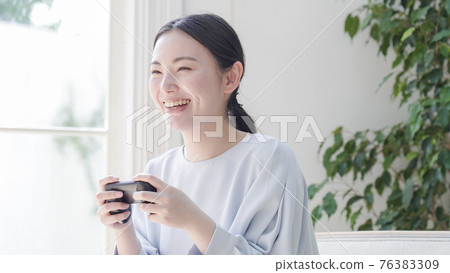 Young woman playing games at home 76383309