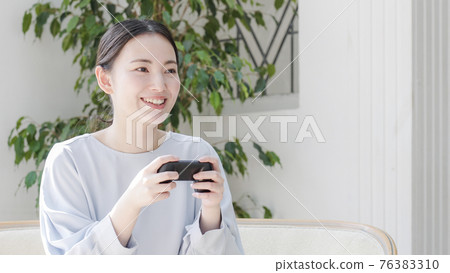 Young woman playing games at home 76383310