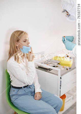 Medical worker taking a swab for corona virus 76387734