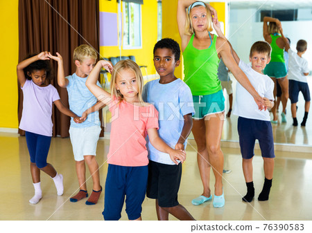 Little boys and girls dancing pair dance in the ballet studio Little boys and girls dancing pair dance in the ballet studio 76390583