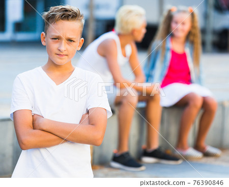 Sad boy having problems with friends 76390846