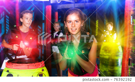 Girl having fun on lasertag arena Girl having fun on lasertag arena 76392192