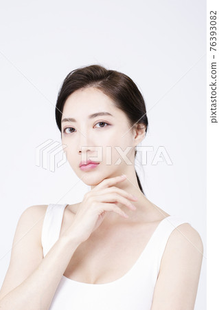 beatiful Asian woman with white sleeveless, white background shot with beauty cosmetics concept beatiful Asian woman with white sleeveless, white background shot with beauty cosmetics concept 76393082