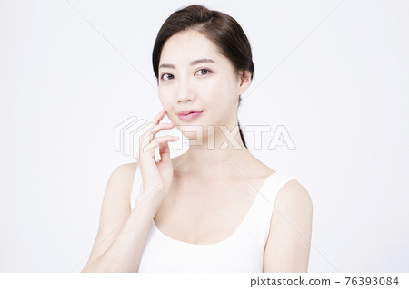 beatiful Asian woman with white sleeveless, white background shot with beauty cosmetics concept beatiful Asian woman with white sleeveless, white background shot with beauty cosmetics concept 76393084