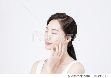 beatiful Asian woman with white sleeveless, white background shot with beauty cosmetics concept beatiful Asian woman with white sleeveless, white background shot with beauty cosmetics concept 76393112