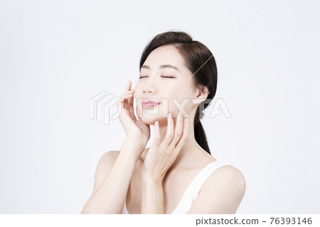 beatiful Asian woman with white sleeveless, white background shot with beauty cosmetics concept beatiful Asian woman with white sleeveless, white background shot with beauty cosmetics concept 76393146