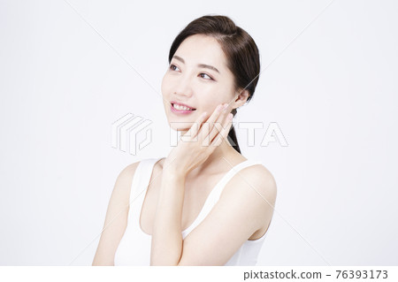 beatiful Asian woman with white sleeveless, white background shot with beauty cosmetics concept beatiful Asian woman with white sleeveless, white background shot with beauty cosmetics concept 76393173
