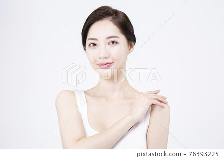 beatiful Asian woman with white sleeveless, white background shot with beauty cosmetics concept beatiful Asian woman with white sleeveless, white background shot with beauty cosmetics concept 76393225