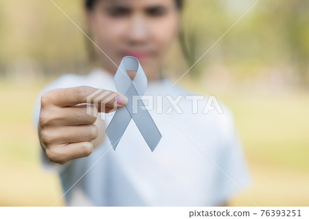 Brain Cancer Awareness month, woman hand holding grey color Ribbon for supporting people living. Healthcare and World cancer day concept Brain Cancer Awareness month, woman hand holding grey color Ribbon for supporting people living. Healthcare and World cancer day concept 76393251
