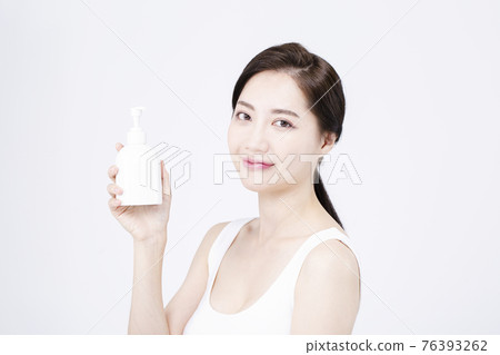 beatiful Asian woman with white sleeveless, white background shot with beauty cosmetics concept beatiful Asian woman with white sleeveless, white background shot with beauty cosmetics concept 76393262