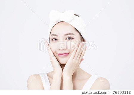 beatiful Asian woman with white sleeveless, white background shot with beauty cosmetics concept beatiful Asian woman with white sleeveless, white background shot with beauty cosmetics concept 76393318