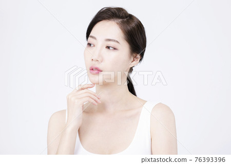beatiful Asian woman with white sleeveless, white background shot with beauty cosmetics concept beatiful Asian woman with white sleeveless, white background shot with beauty cosmetics concept 76393396