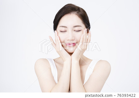 beatiful Asian woman with white sleeveless, white background shot with beauty cosmetics concept beatiful Asian woman with white sleeveless, white background shot with beauty cosmetics concept 76393422