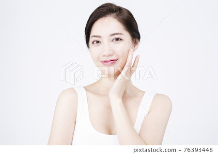 beatiful Asian woman with white sleeveless, white background shot with beauty cosmetics concept beatiful Asian woman with white sleeveless, white background shot with beauty cosmetics concept 76393448