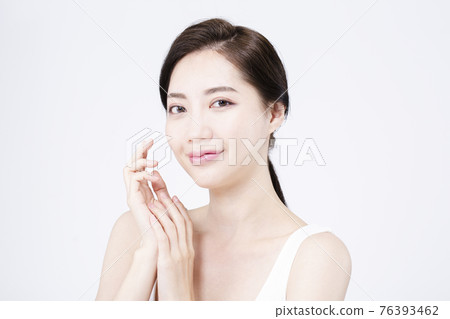 beatiful Asian woman with white sleeveless, white background shot with beauty cosmetics concept beatiful Asian woman with white sleeveless, white background shot with beauty cosmetics concept 76393462