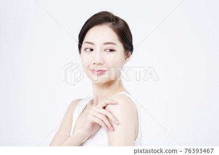 beatiful Asian woman with white sleeveless, white background shot with beauty cosmetics concept beatiful Asian woman with white sleeveless, white background shot with beauty cosmetics concept 76393467