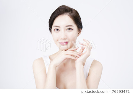 beatiful Asian woman with white sleeveless, white background shot with beauty cosmetics concept 76393471