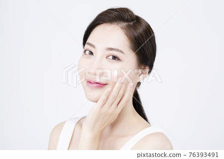 beatiful Asian woman with white sleeveless, white background shot with beauty cosmetics concept beatiful Asian woman with white sleeveless, white background shot with beauty cosmetics concept 76393491