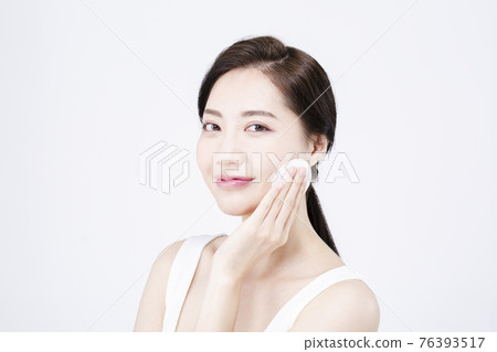 beatiful Asian woman with white sleeveless, white background shot with beauty cosmetics concept beatiful Asian woman with white sleeveless, white background shot with beauty cosmetics concept 76393517