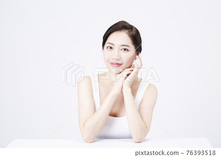 beatiful Asian woman with white sleeveless, white background shot with beauty cosmetics concept beatiful Asian woman with white sleeveless, white background shot with beauty cosmetics concept 76393518