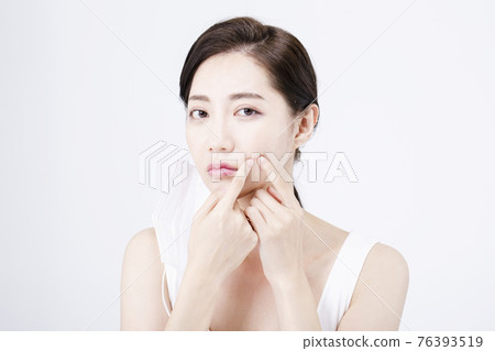 beatiful Asian woman with white sleeveless, white background shot with beauty cosmetics concept beatiful Asian woman with white sleeveless, white background shot with beauty cosmetics concept 76393519
