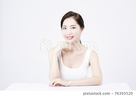 beatiful Asian woman with white sleeveless, white background shot with beauty cosmetics concept beatiful Asian woman with white sleeveless, white background shot with beauty cosmetics concept 76393520