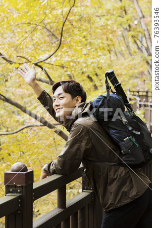 Asian handsome man trekking, climbing autumn mountain Asian handsome man trekking, climbing autumn mountain 76393546