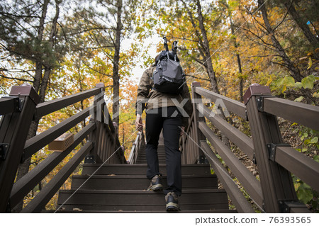 Asian handsome man trekking, climbing autumn mountain Asian handsome man trekking, climbing autumn mountain 76393565